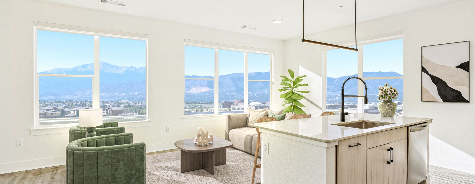 a room with a sink and a couch and a table with a plant