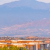 Scenic apartment complex with breathtaking mountain views, surrounded by lush greenery and vibrant community living at The Aven in Colorado Springs